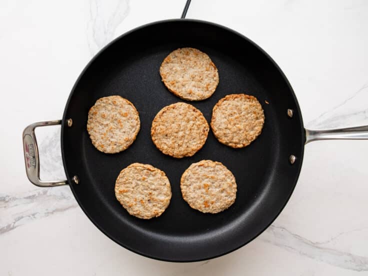 Browning sausage patties in a skillet.