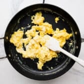 Scrambled eggs in a skillet.
