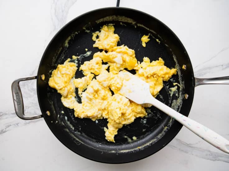 Scrambled eggs in a skillet.