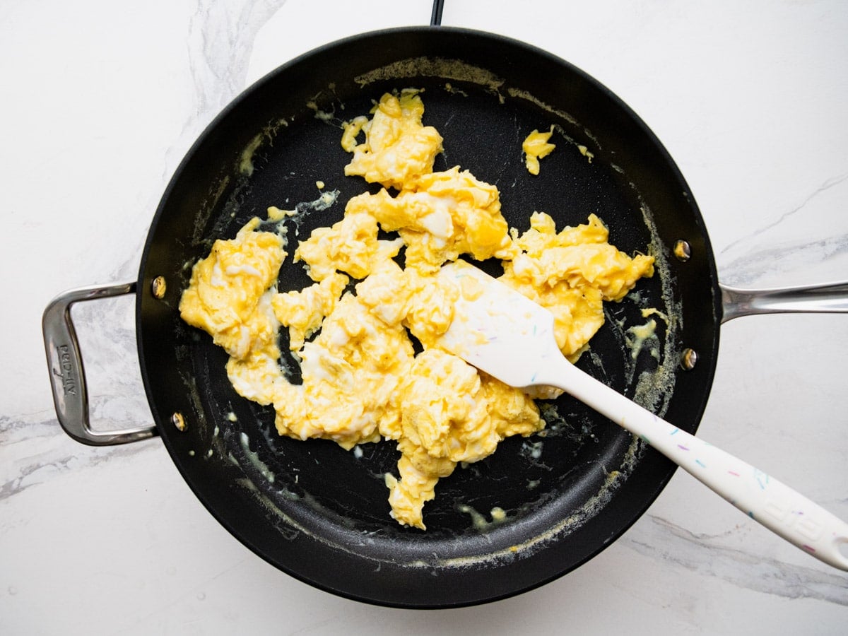 Scrambled eggs in a skillet.