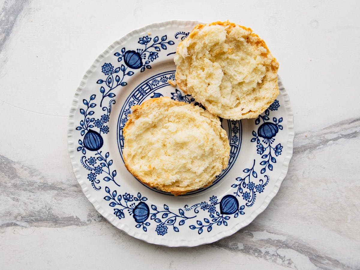 A split open biscuit on a plate.