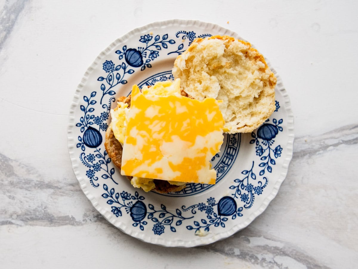 Adding the cheese to the sandwich.