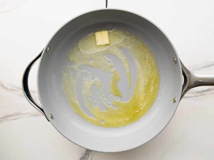 Melting butter in a skillet.