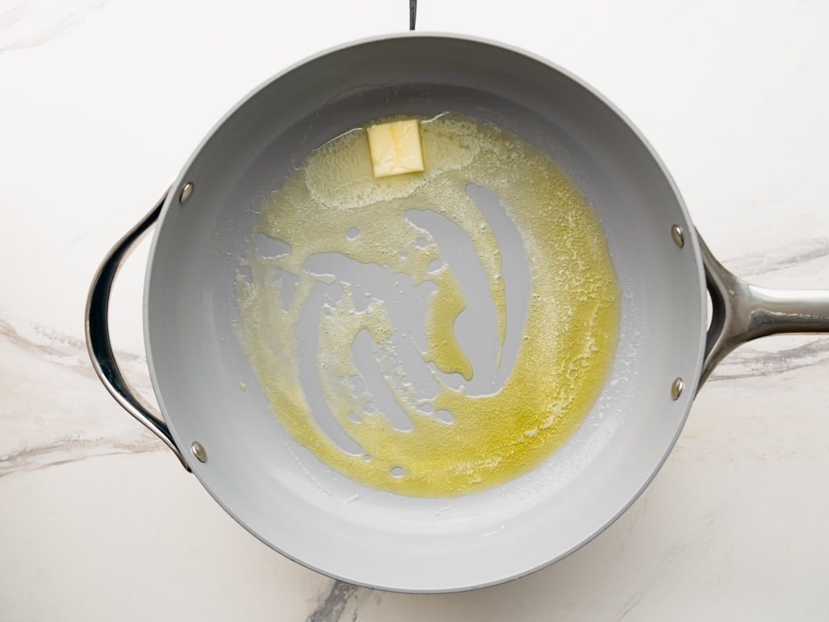 Melting butter in a skillet.