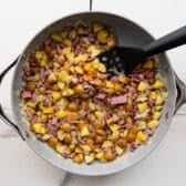 Pressing corned beef hash to make it crispy.