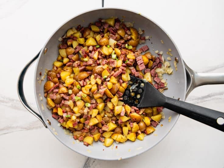 Process shot showing how to make corned beef hash.