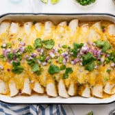 Horizontal overhead image of a pan of creamy chicken enchiladas.