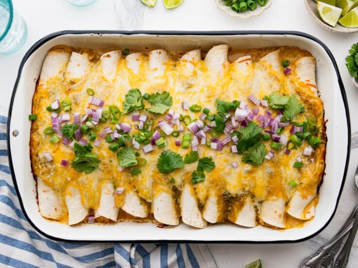 Horizontal overhead image of a pan of creamy chicken enchiladas.