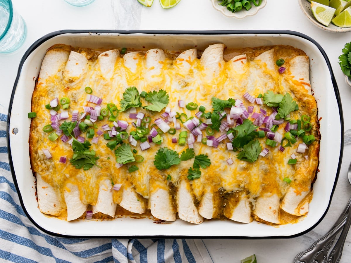 Horizontal overhead image of a pan of creamy chicken enchiladas.