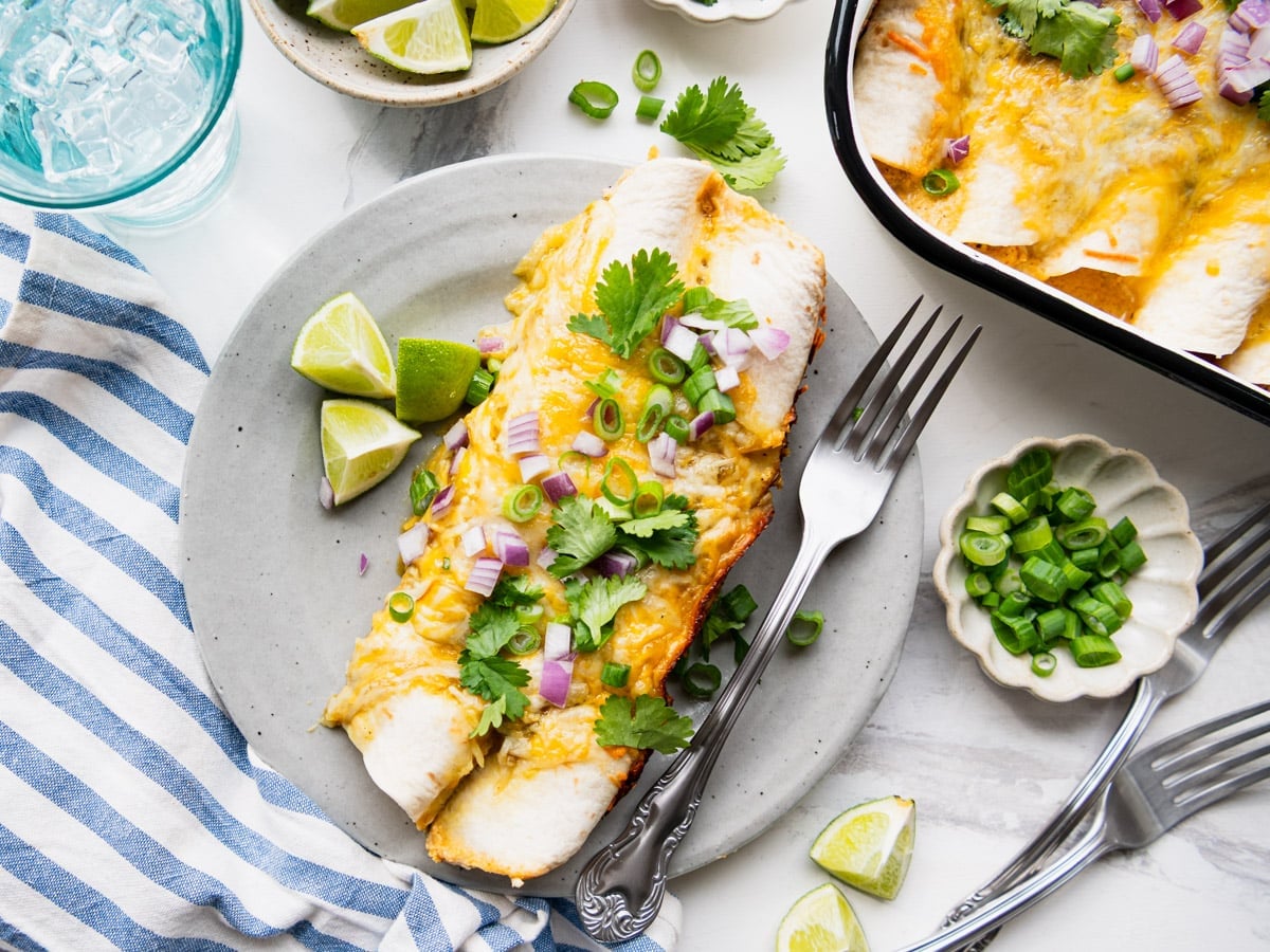 Horizontal overhead shot of creamy chicken enchiladas on a plate.