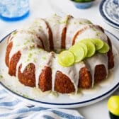 Horizontal side shot of a glazed key lime bundt cake on a serving platter before slicing.