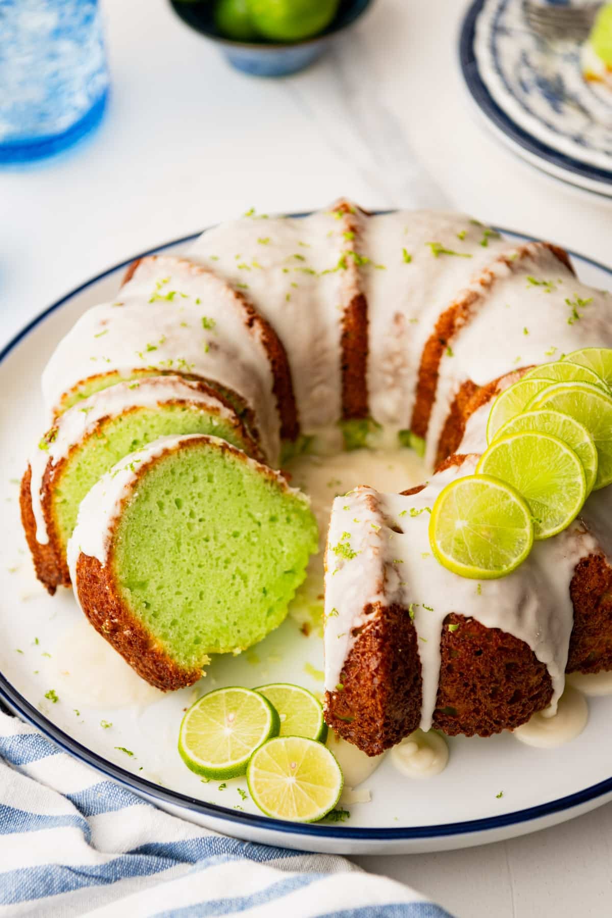 Side shot of a sliced key lime cake.