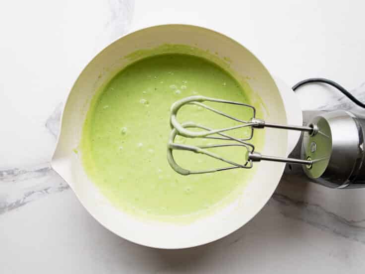 Mixing the cake batter with an electric hand mixer.
