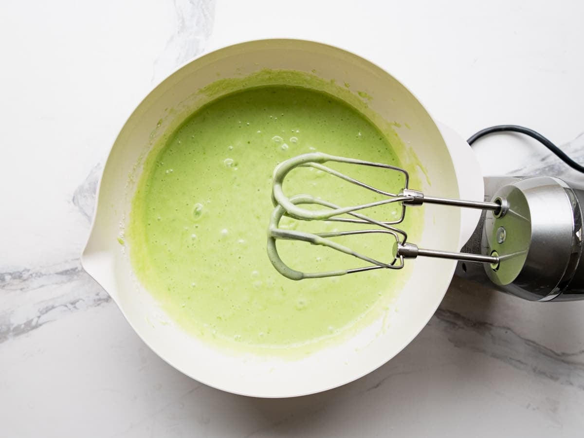 Mixing the cake batter with an electric hand mixer.