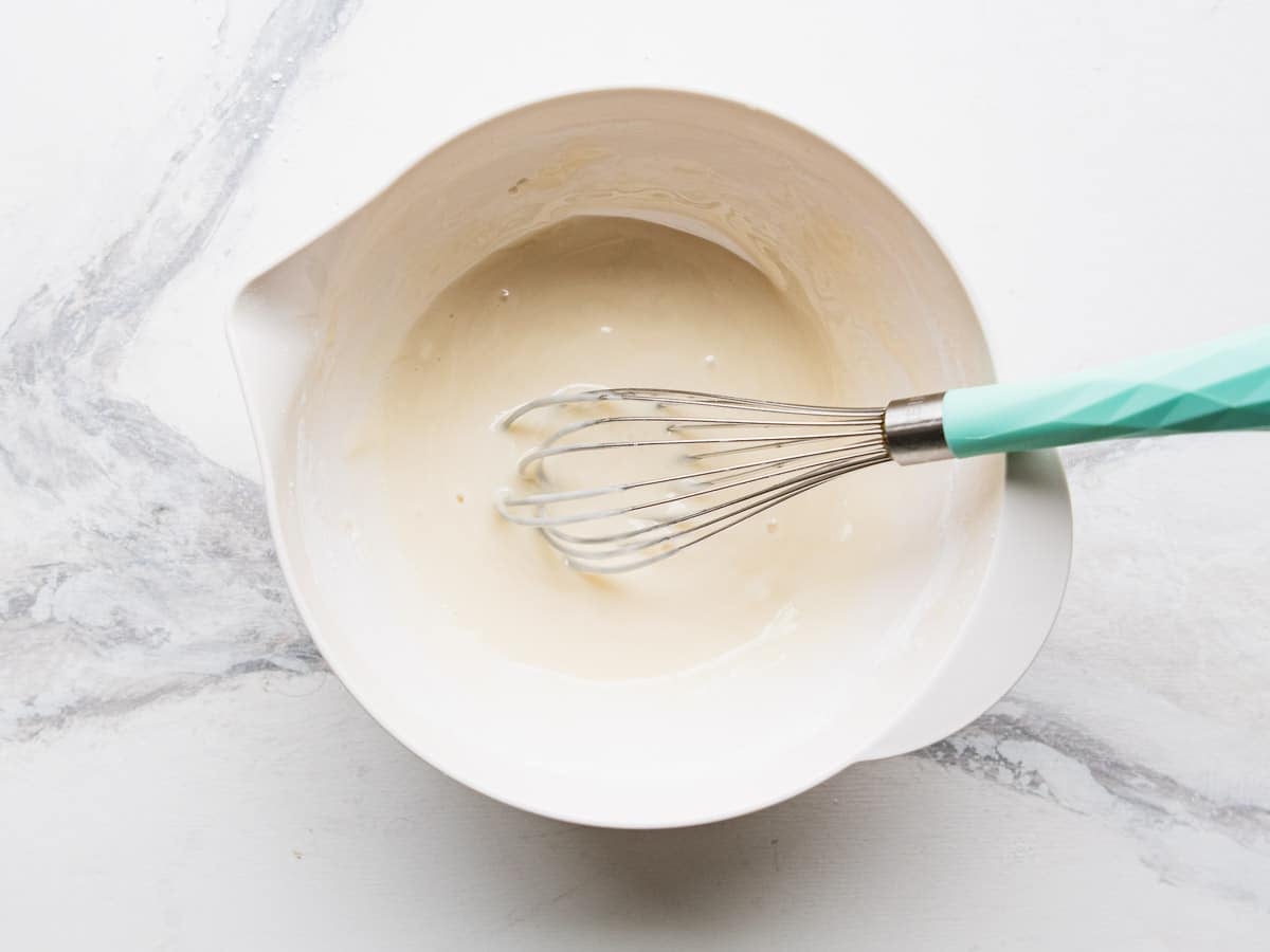 Whisking together the key lime glaze.