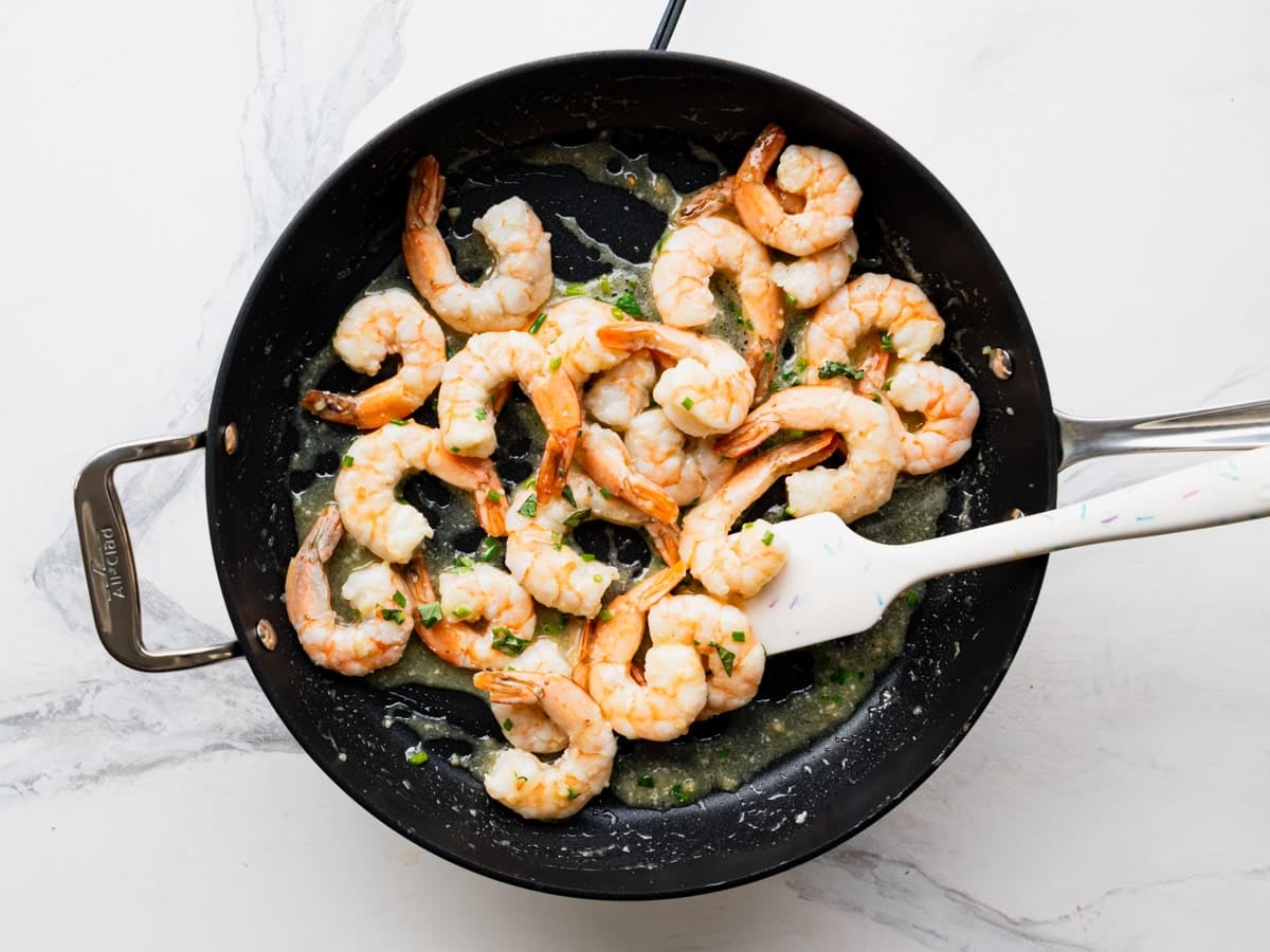 Tossing the shrimp in the lemon garlic shrimp.
