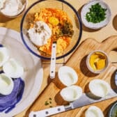 Process shot showing how to make the filling and slice open the eggs for a deviled eggs recipe.