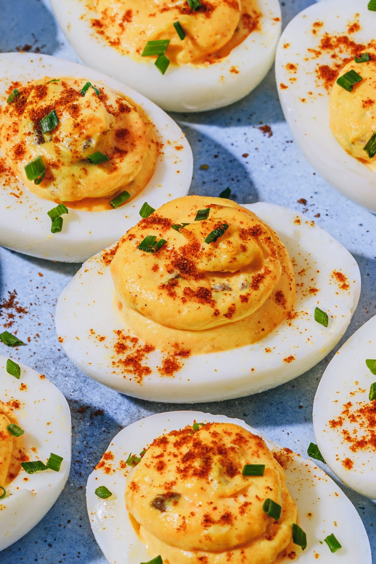 Side shot of Southern deviled eggs on a blue platter.