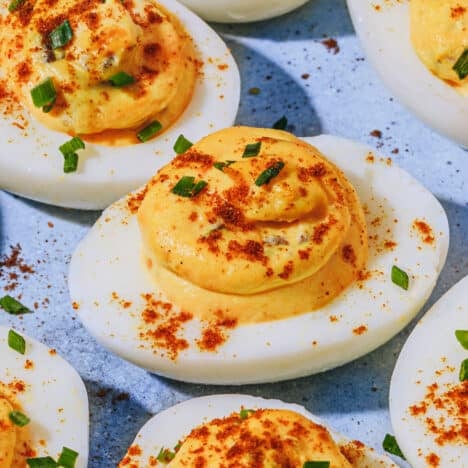 Square side shot of Southern deviled eggs on a blue serving tray.