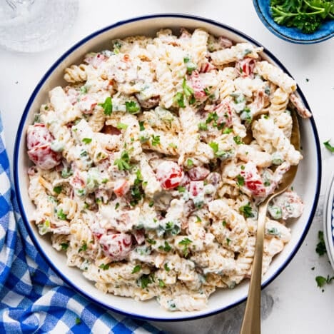Square overhead shot of a creamy bacon ranch pasta salad recipe in a serving bowl.