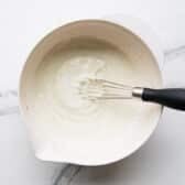 Whisking together the dressing.