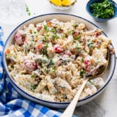 Horizontal side shot of a bowl of bacon ranch pasta salad.