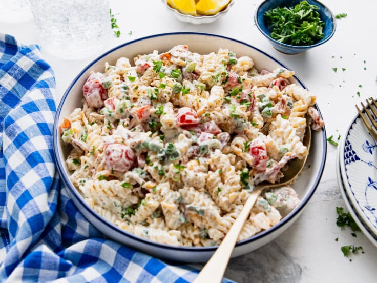 Horizontal side shot of a bowl of bacon ranch pasta salad.