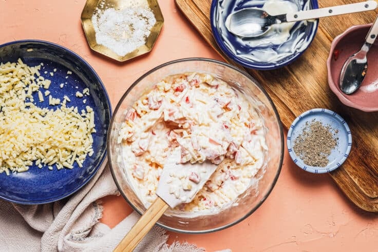Stirring together pimento cheese.