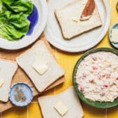 Spreading butter on bread slices.