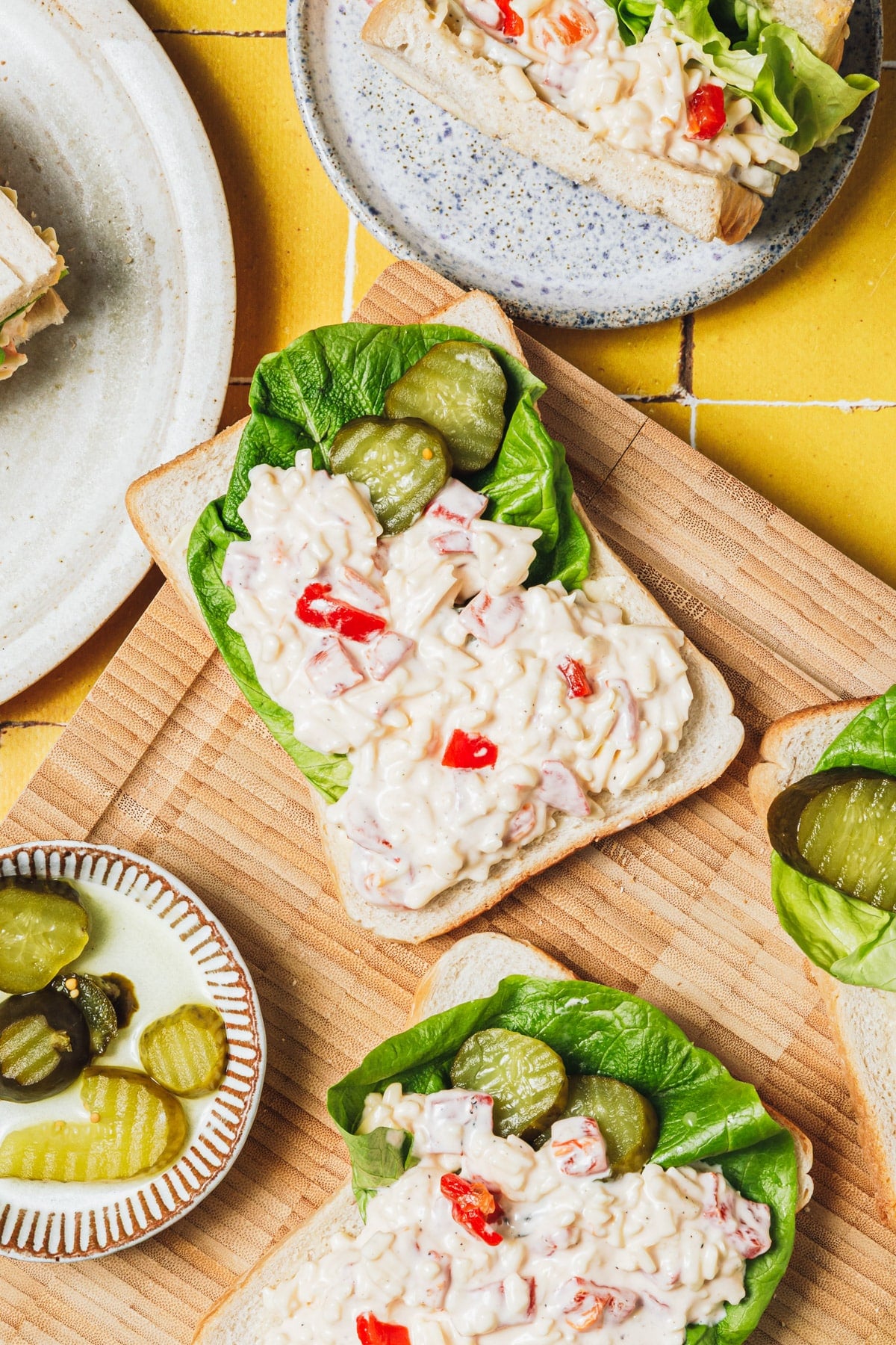 Overhead image of pimento cheese sandwiches on a cutting board.