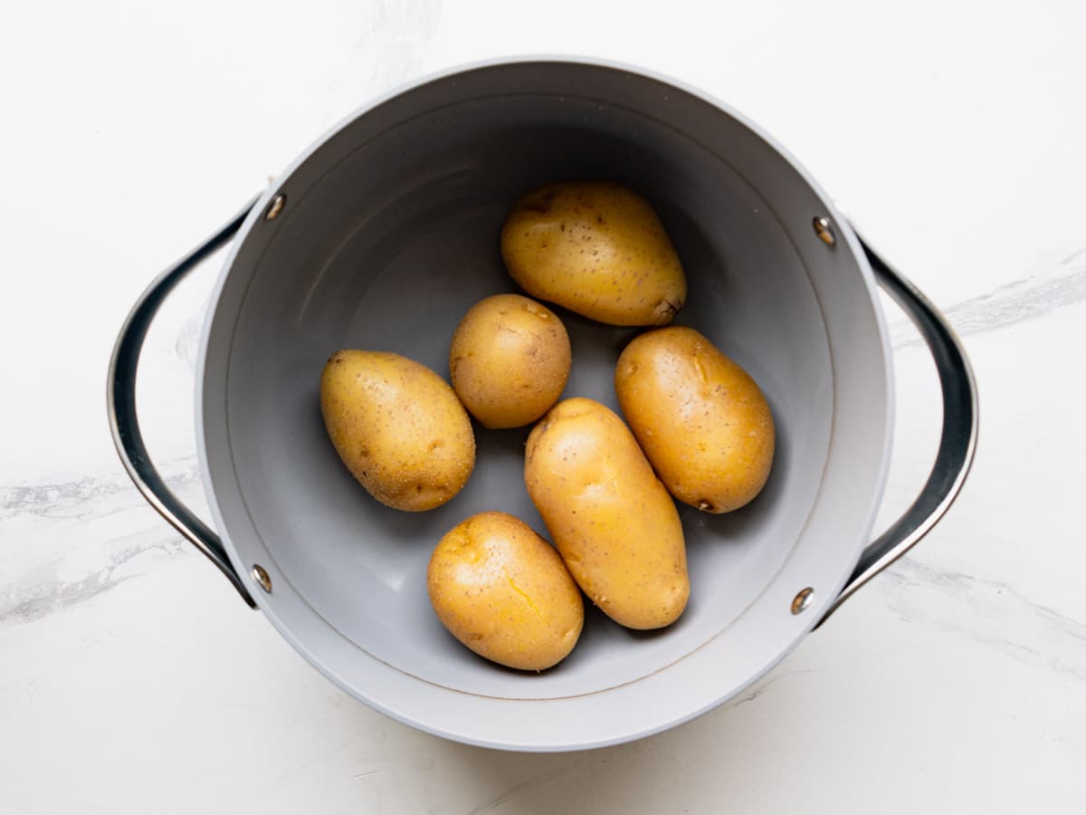 Boiled yukon gold potatoes in a pot.
