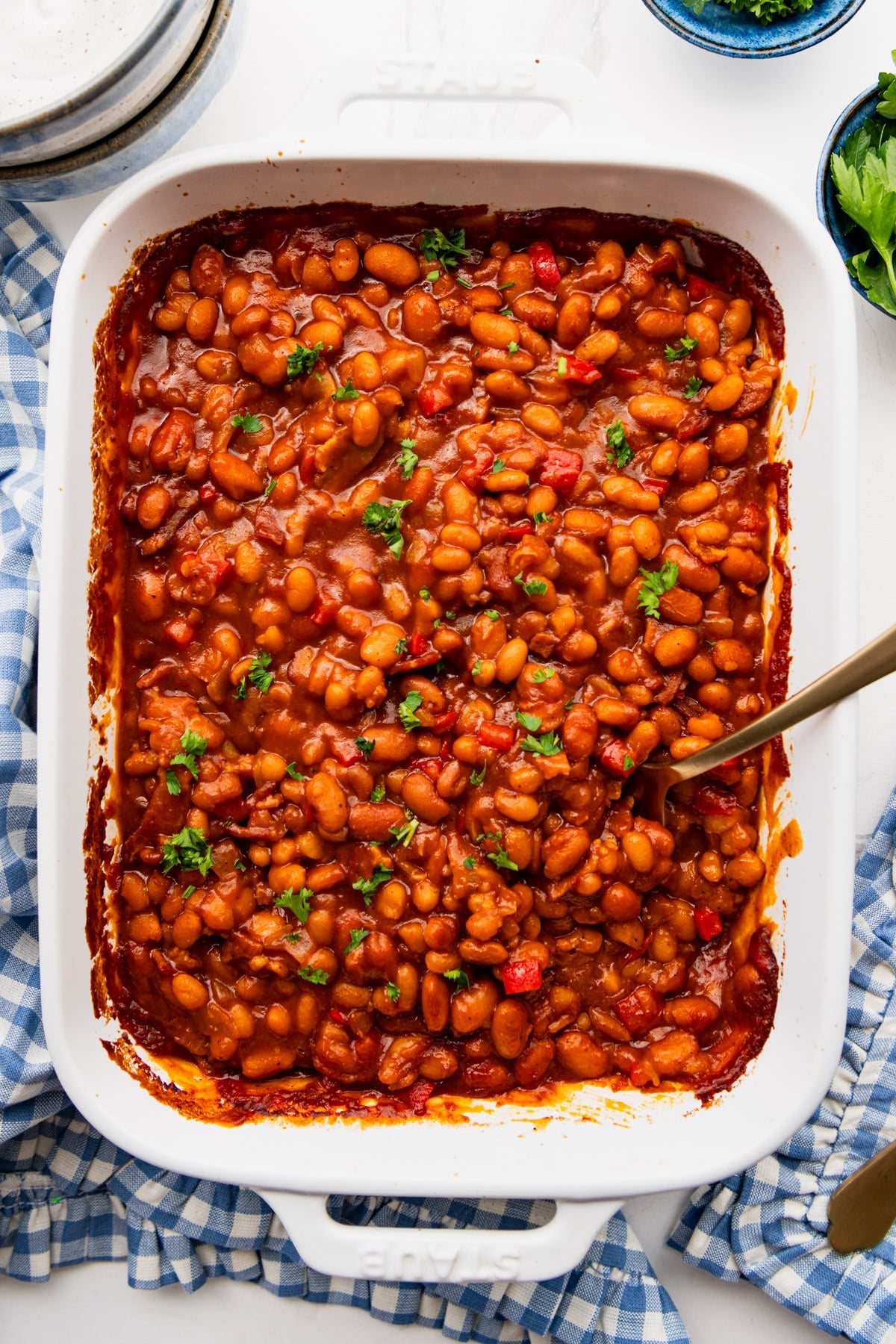 Overhead image of a white dish full of easy bbq baked beans.
