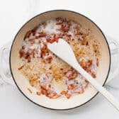 Cooking bacon in a skillet.