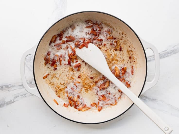Cooking bacon in a skillet.