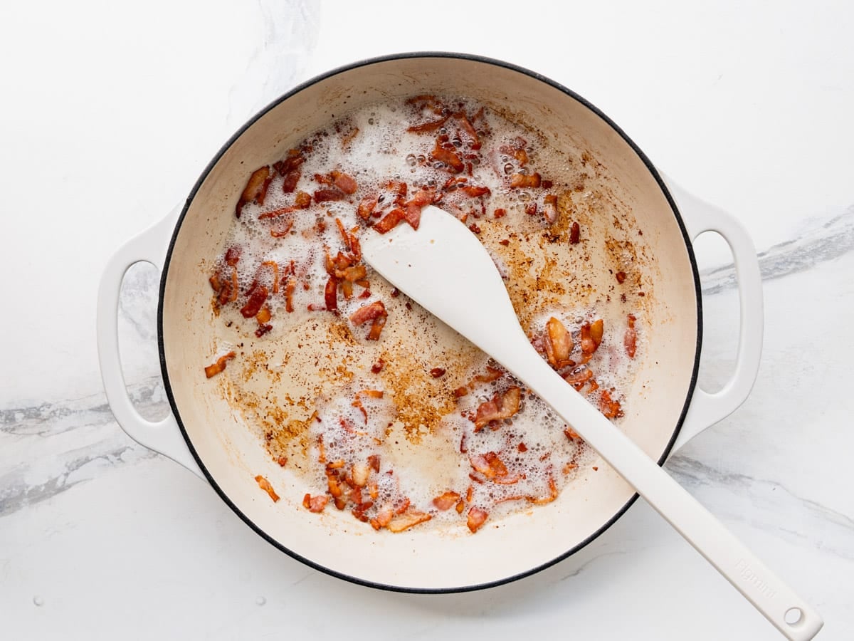 Cooking bacon in a skillet.