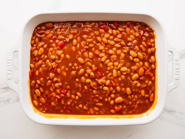 BBQ baked beans in a dish before they go in the oven.