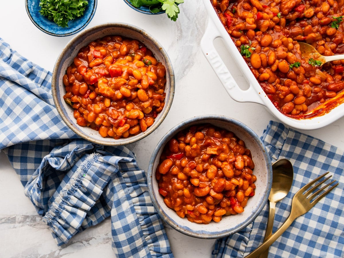 Horizontal overhead shot of bbq baked beans in individual serving bowls.