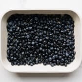 Lemon blueberry filling spread in a baking dish.