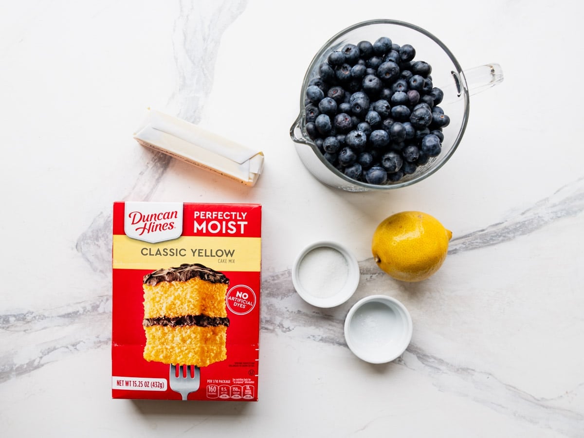 Ingredients for a blueberry cobbler with cake mix.