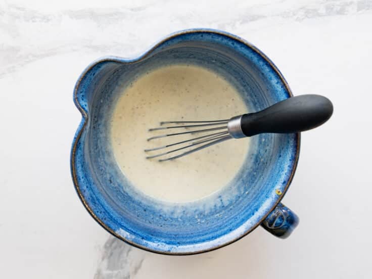Whisking together the creamy dressing.