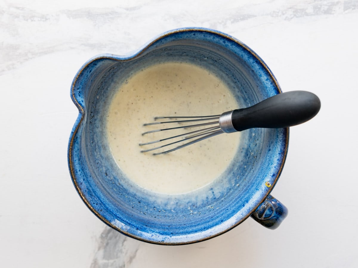 Whisking together the creamy dressing.