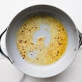 Garlic butter sauce in a skillet.