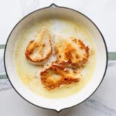 Browning chicken cutlets in the skillet.