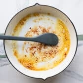 Cooking garlic in butter in the skillet.