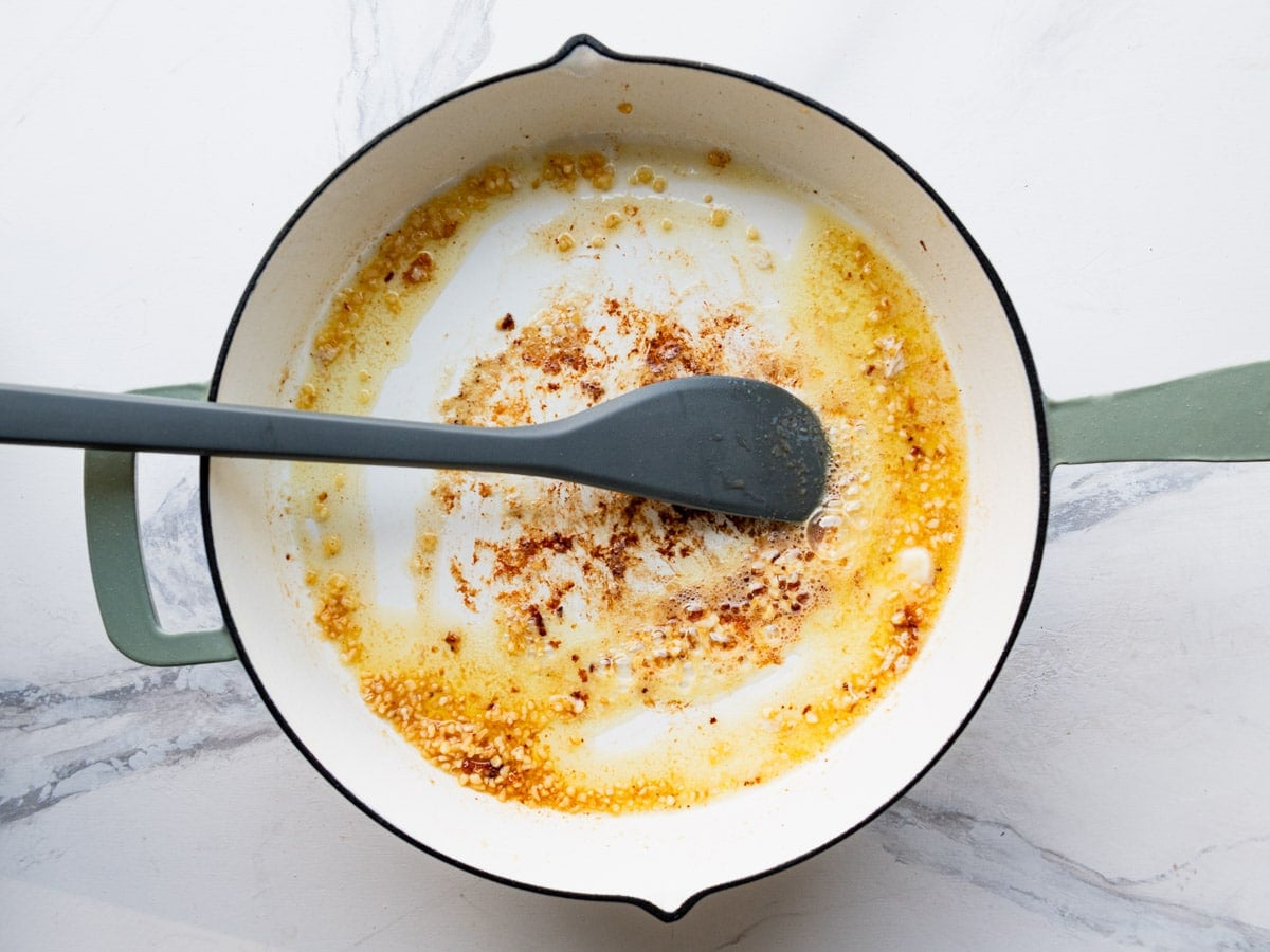 Cooking garlic in butter in the skillet.