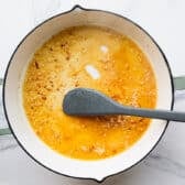 Stirring together the pan sauce for an easy skillet lemon chicken recipe.