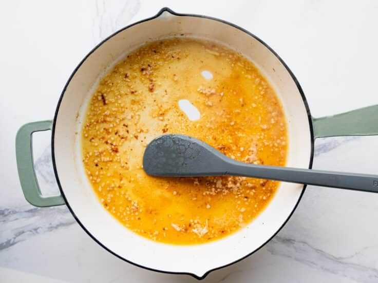 Stirring together the pan sauce for an easy skillet lemon chicken recipe.