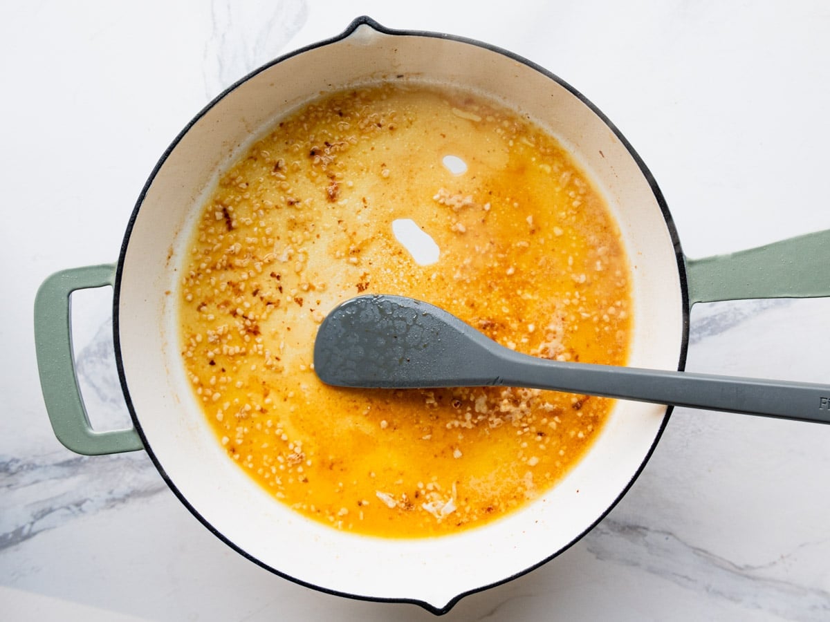 Stirring together the pan sauce for an easy skillet lemon chicken recipe.