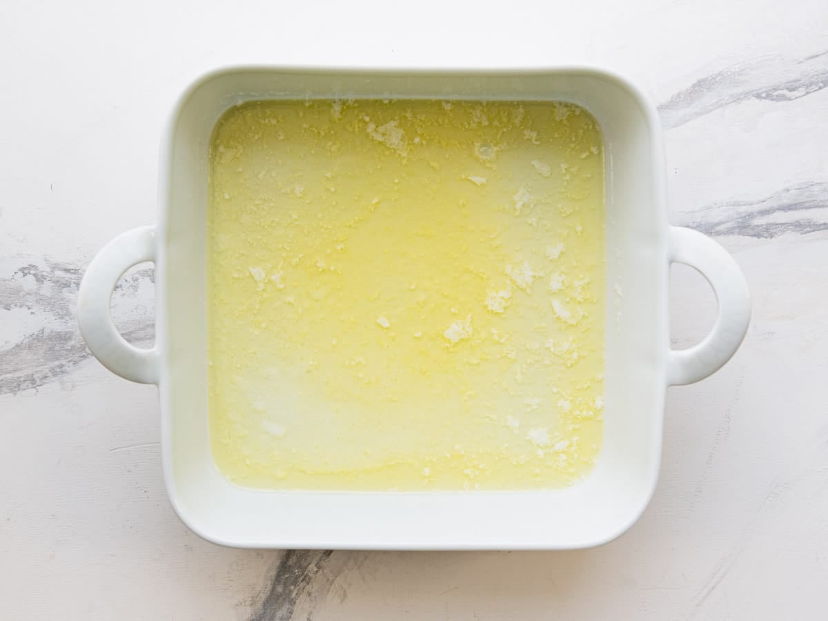 Melted butter in a white baking dish.