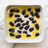 Sprinkling sugar on top of the cobbler before baking.